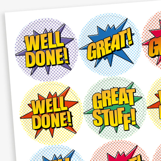 Sheet of 32mm round sherbet-scented stickers featuring vibrant pop art designs with phrases like 'Well Done!', 'Great!', and 'Great Stuff!' in bold comic-style lettering against colourful backgrounds; designed for rewarding pupils' achievements.