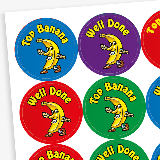 A sheet of 32mm circular stickers with banana scent.  Each featuring a smiling banana who is dancing on brightly coloured backgrounds of red, purple, blue and green.  Phrases include 'Well Done' and 'Top Banana' above the image.
