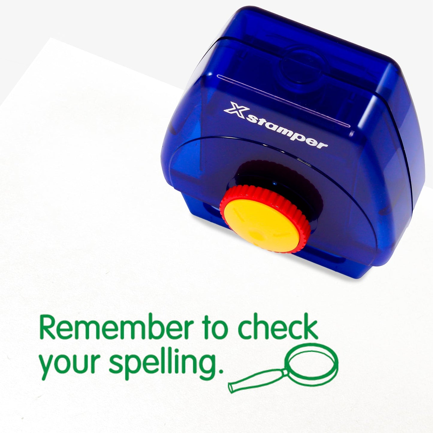 One Twist N Stamp brick in green ink saying 'Remember to check your spelling' with a magnifying glass to the bottom right hand side