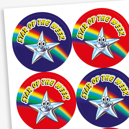 Sheet of 25mm round 'Star of the Week' stickers featuring a smiling silver star character set against various vibrant backgrounds, including red, blue, and purple, with rainbow accents; designed to celebrate and motivate pupils for outstanding achievements
