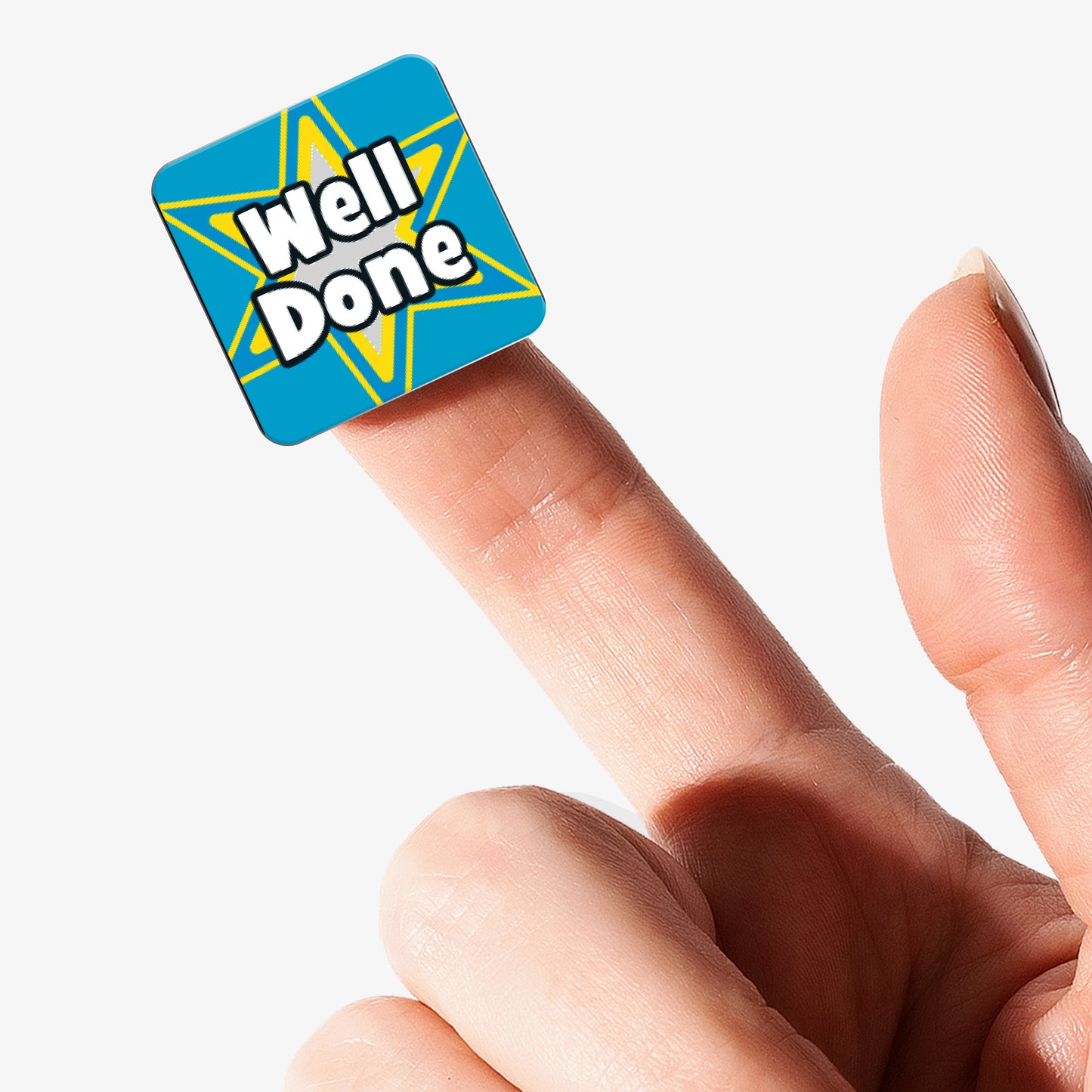 Blue square Well Done reward sticker with star design displayed on a fingertip