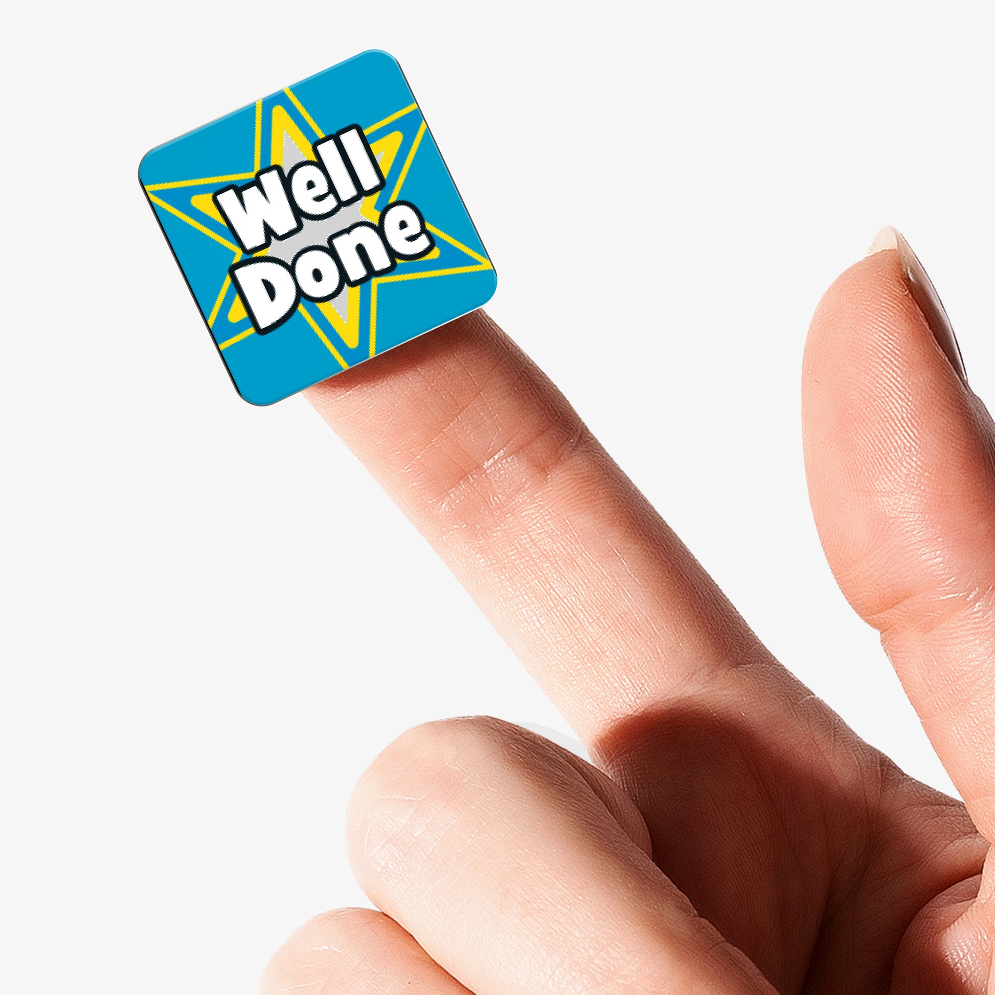 Blue square Well Done reward sticker with star design displayed on a fingertip