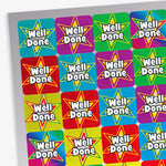 Close-up view of colourful Well Done reward stickers arranged on a sticker sheet