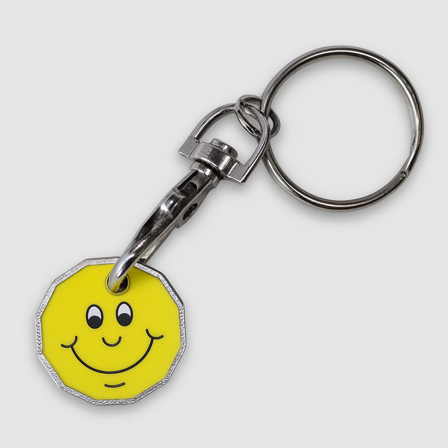 Trolley coin keyring with a smiley face design on a yellow background
