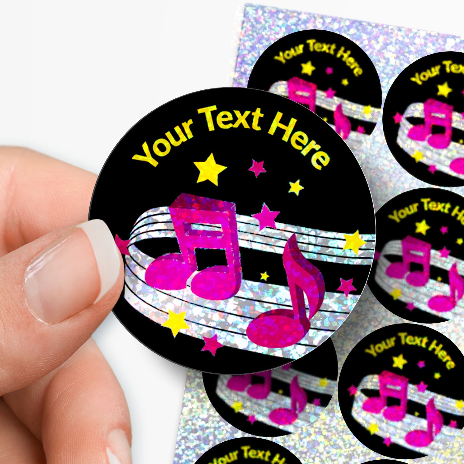 Personalizable music-themed stickers with a hand holding one, on a white background.