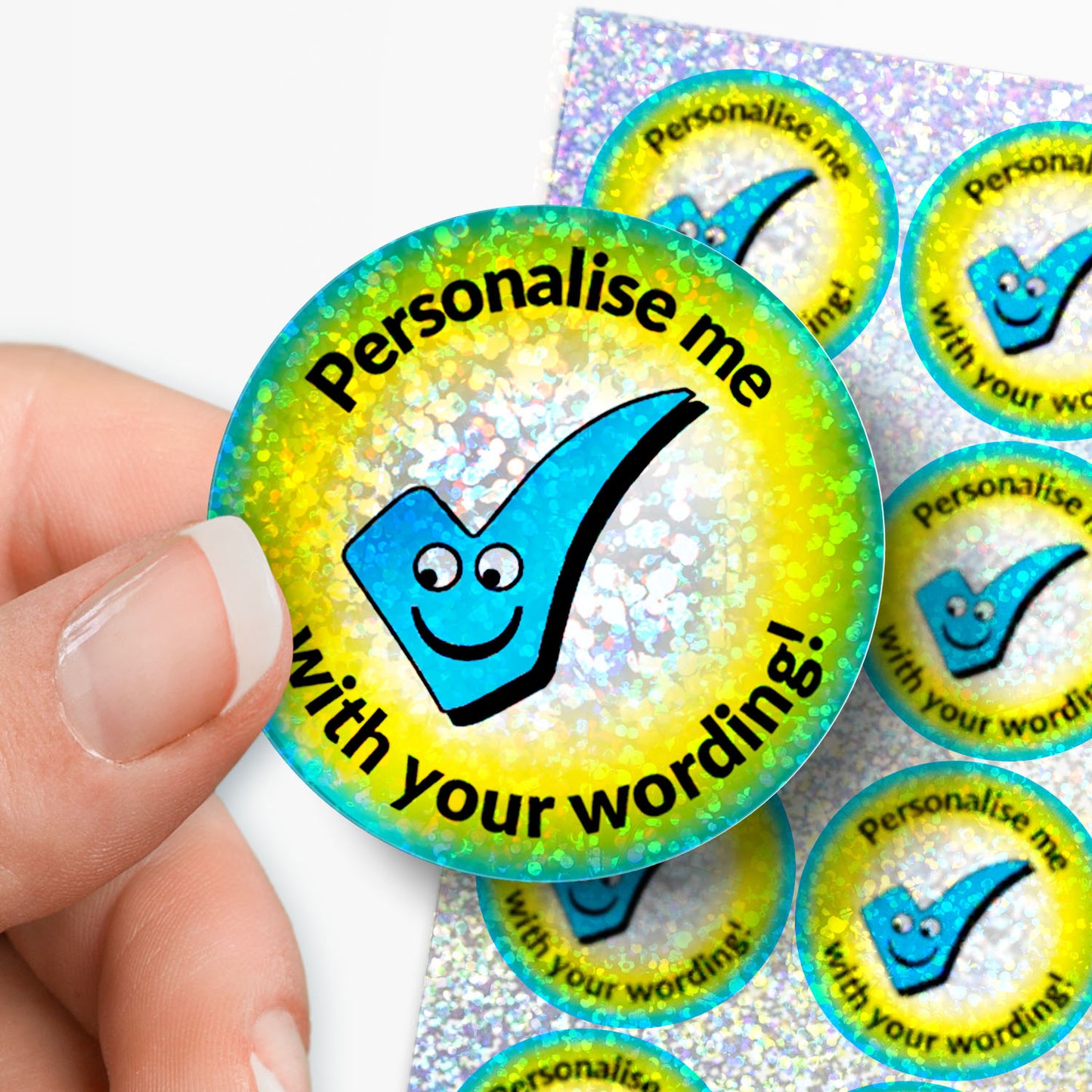 Glittery sticker with a checkmark and text 'Personalise me with your wording!' held by a hand.