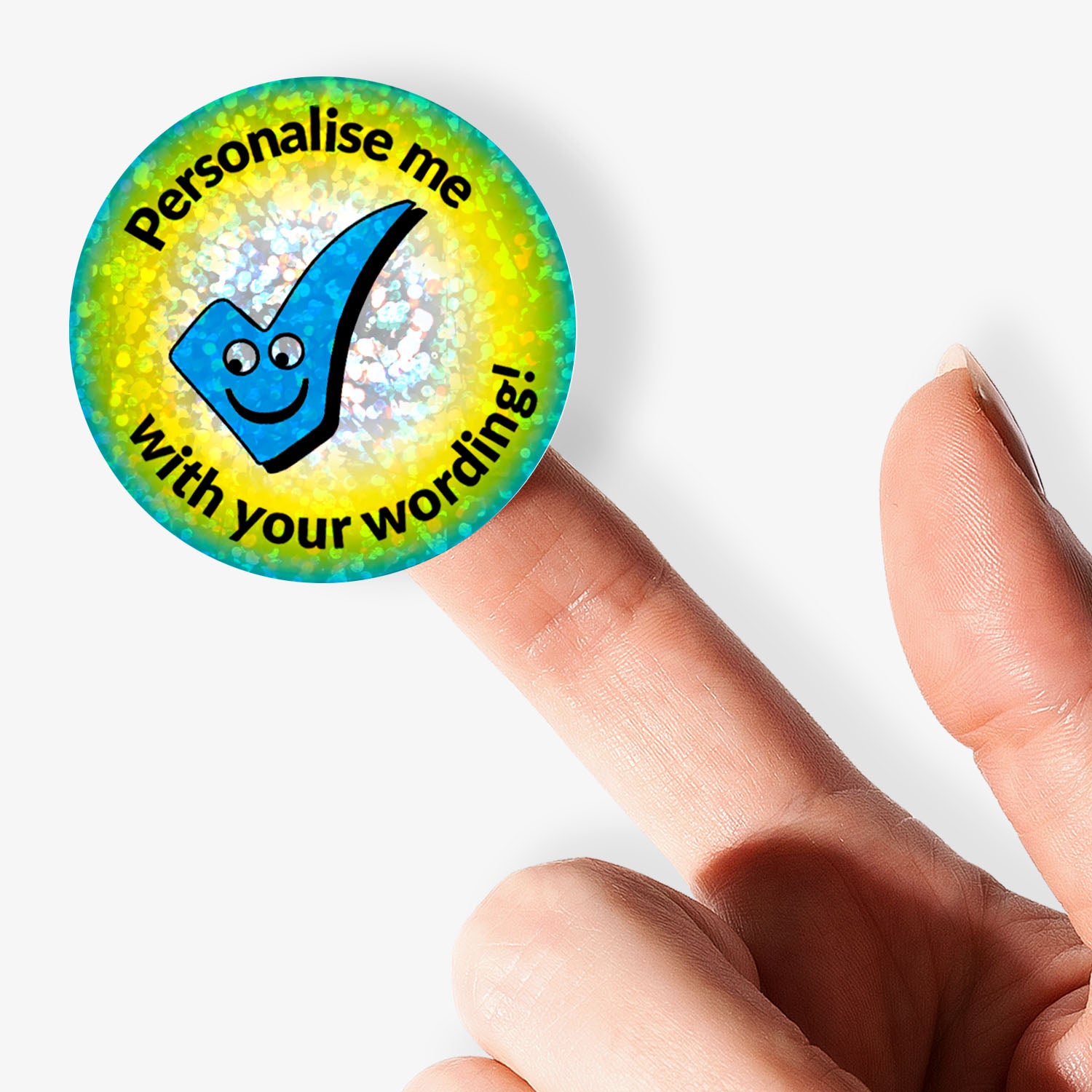 Round customisable sticker with a checkmark and text held between fingers on a white background