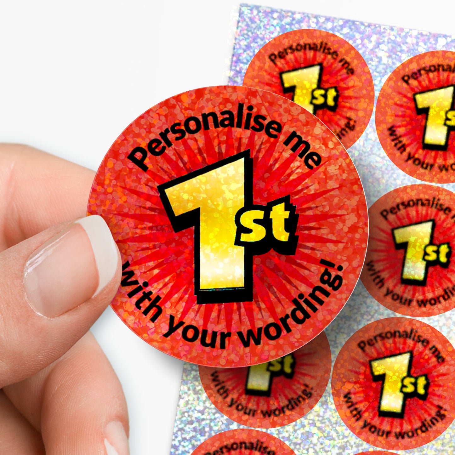 Red stickers with 'Personalise me 1st' text held by a hand on a white background
