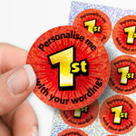 Red stickers with 'Personalise me 1st' text held by a hand on a white background