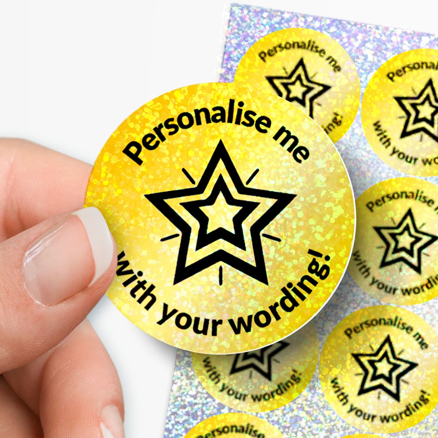 Yellow stickers with star design and text 'Personalise me with your wording!' held by a hand.