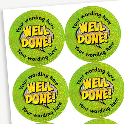 Sheet of round, holographic green stickers, each featuring a silver speech bubble at the centre overlaid with the wording 'WELL DONE!' in gold. Surrounding is placeholder text reading 'Your wording here' above and below, indicating customisable areas for personalised messages