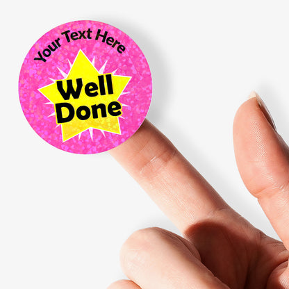 Pink personalised holographic sticker with 'Well Done' text held by a finger.