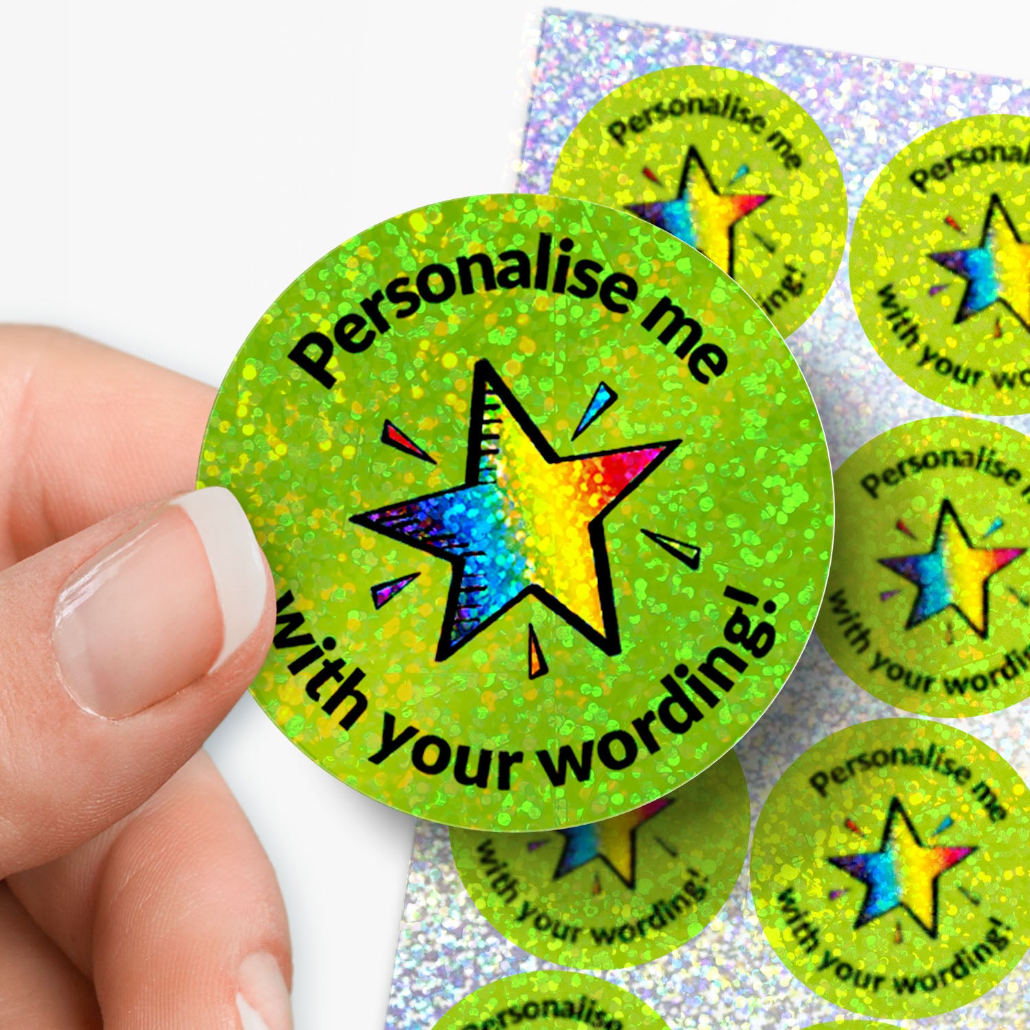 Hand holding a green star-shaped sticker with 'Personalise me with your wording!' text.