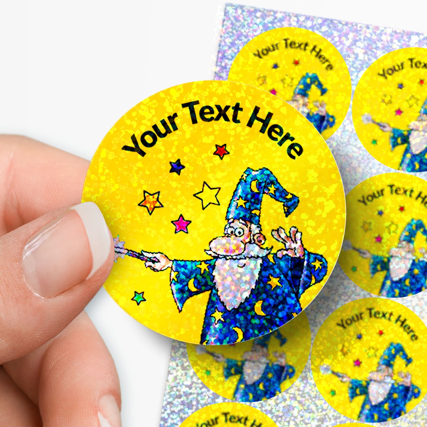 Personalised holographic stickers with a wizard design and 'Your Text Here' text, held by a hand.