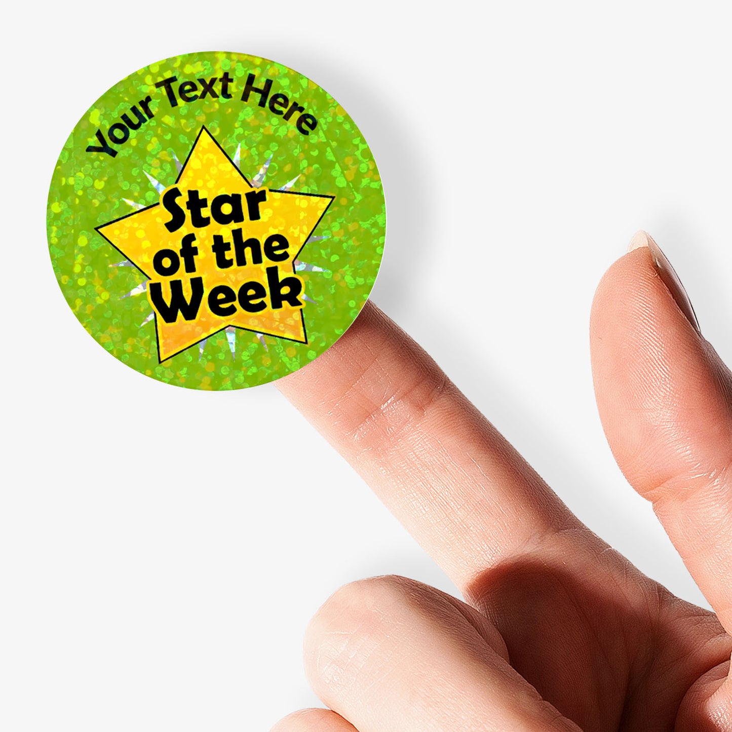 Circular personalised holographic green label with yellow star and text 'Star of the Week' held by a finger.
