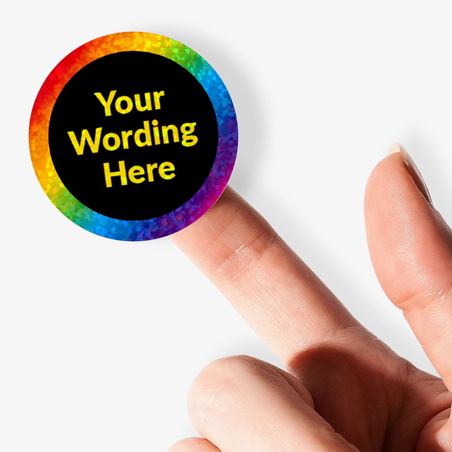 Personalised holographic round sticker with rainbow border and customizable text held by a finger.