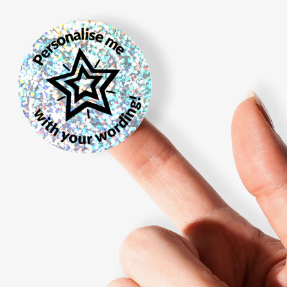 Round customisable holographic Silver sticker with star design and text 'Personalise me with your wording!' held by a finger.