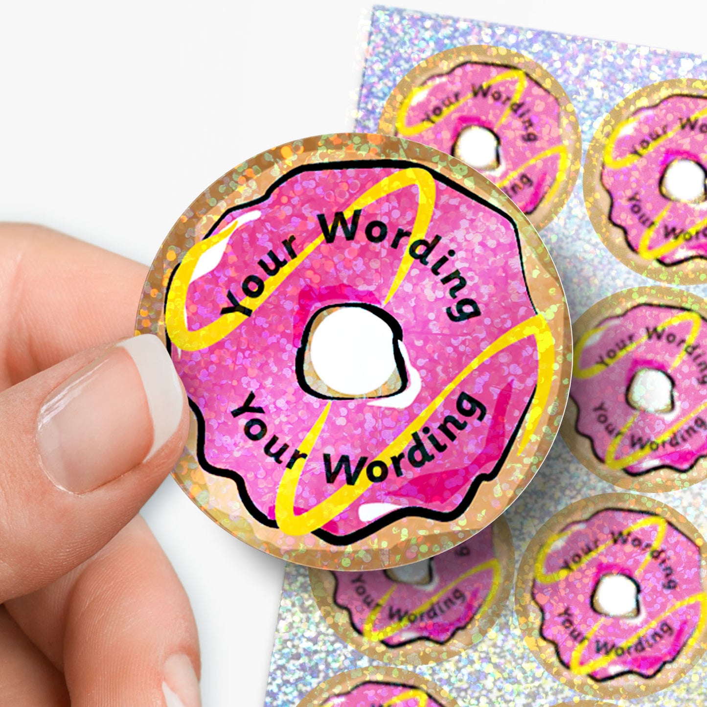 Pink donut-shaped product with 'Your Wording' text, held by a hand against a white background.