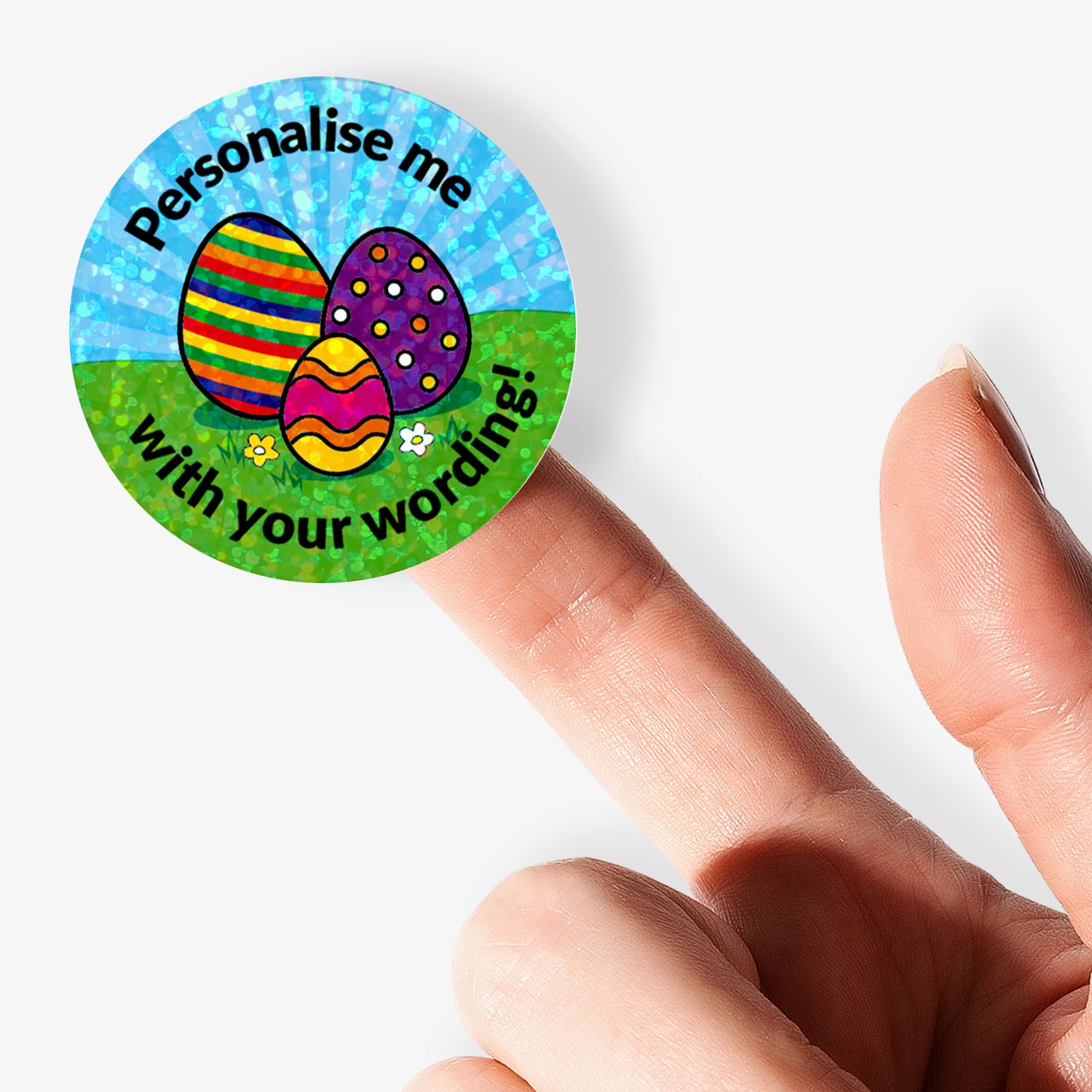 Round customisable sticker with Easter eggs and text held by a finger on a white background
