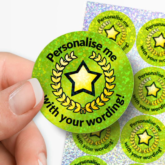 Green badge with star design and 'Personalise me with your wording!' text, held by a hand.