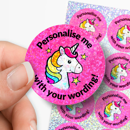 Pink unicorn stickers with 'Personalise me with your wording!' text, held by a hand.