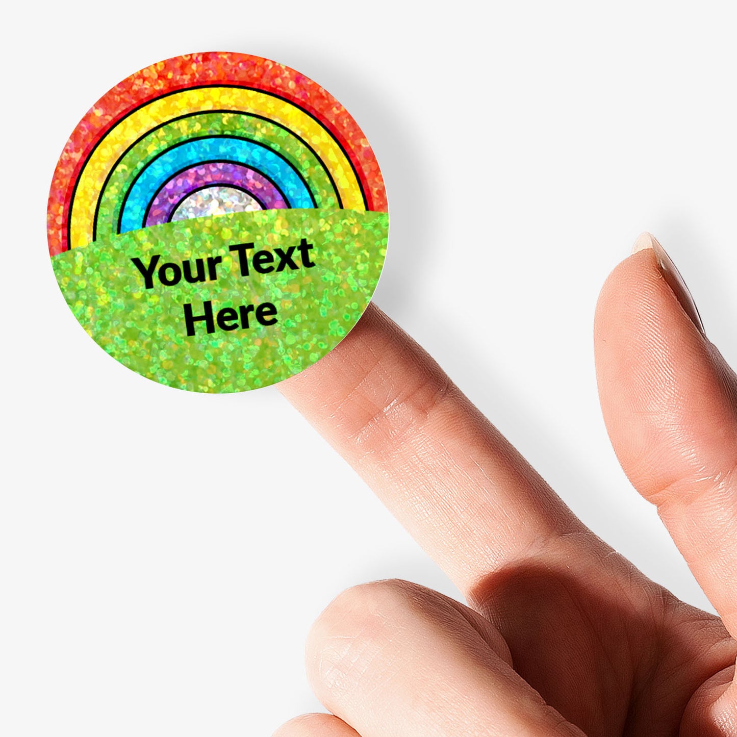Colorful rainbow sticker with customisable text held by a finger.