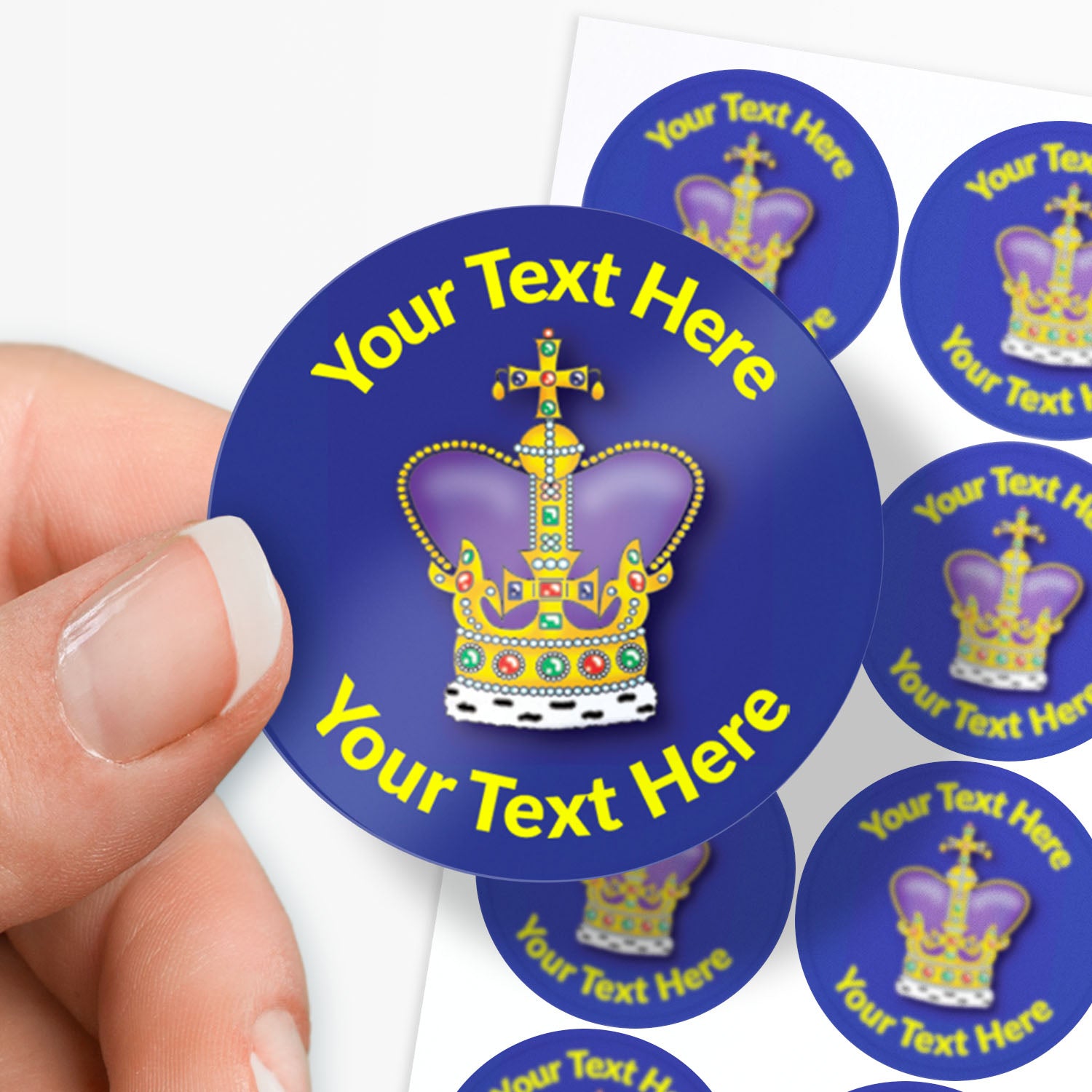 Personalizable sticker with a crown design and text area held by a hand.