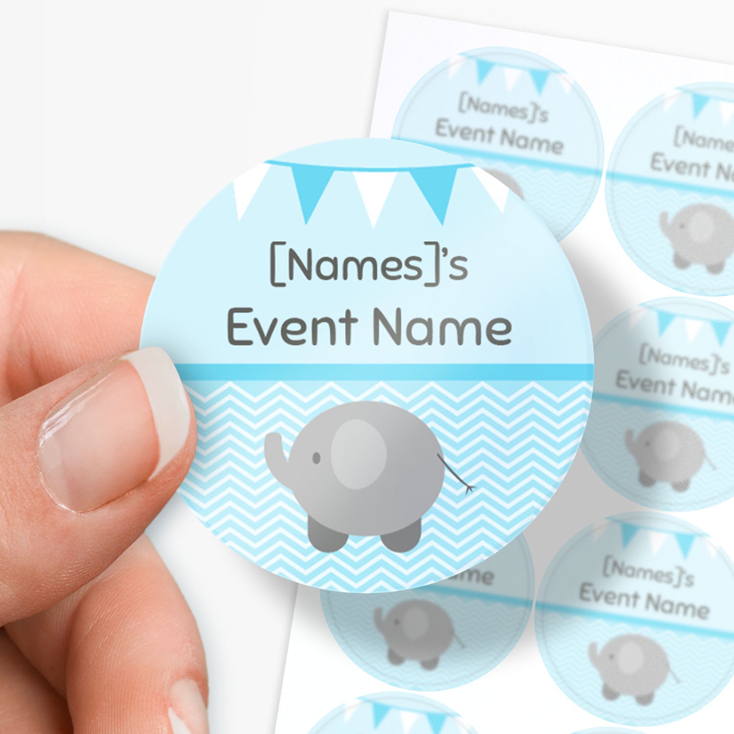 Sheet of blue circular sticker with an elephant and text being held by a finger and thumb