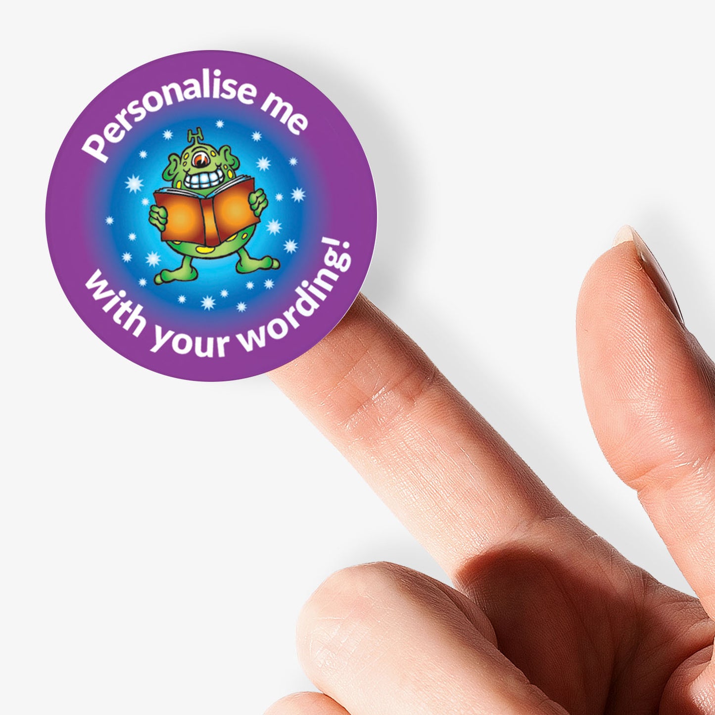 Round customizable sticker with a purple border held between fingers on a white background