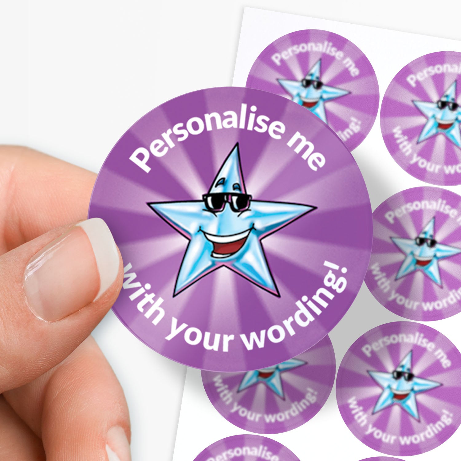 Purple stickers with a star design and text 'Personalise me with your wording!' held by a hand.