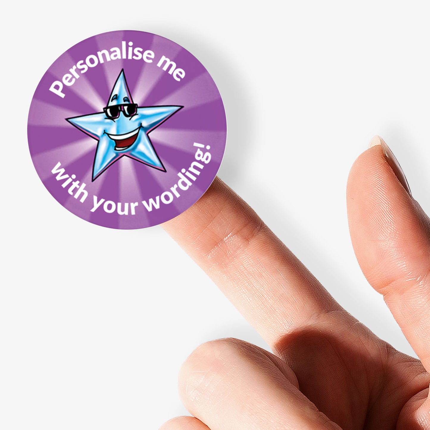 Circular sticker with a star with sunglasses design and text 'Personalise me with your wording!' held on finger.
