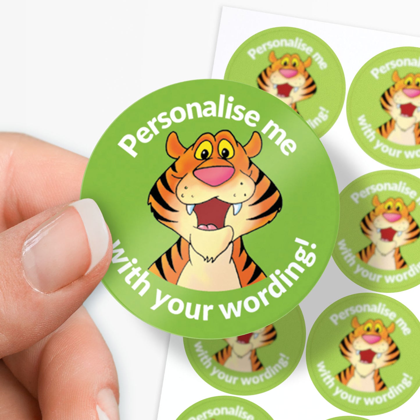 Circular green sticker with a tiger illustration and text 'Personalise me with your wording!' held by a hand.