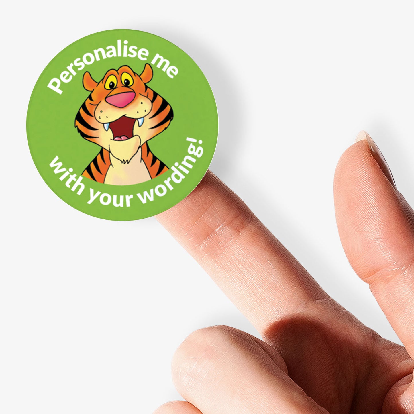 Round sticker with a tiger design and text 'Personalise me with your wording!' held by a finger.