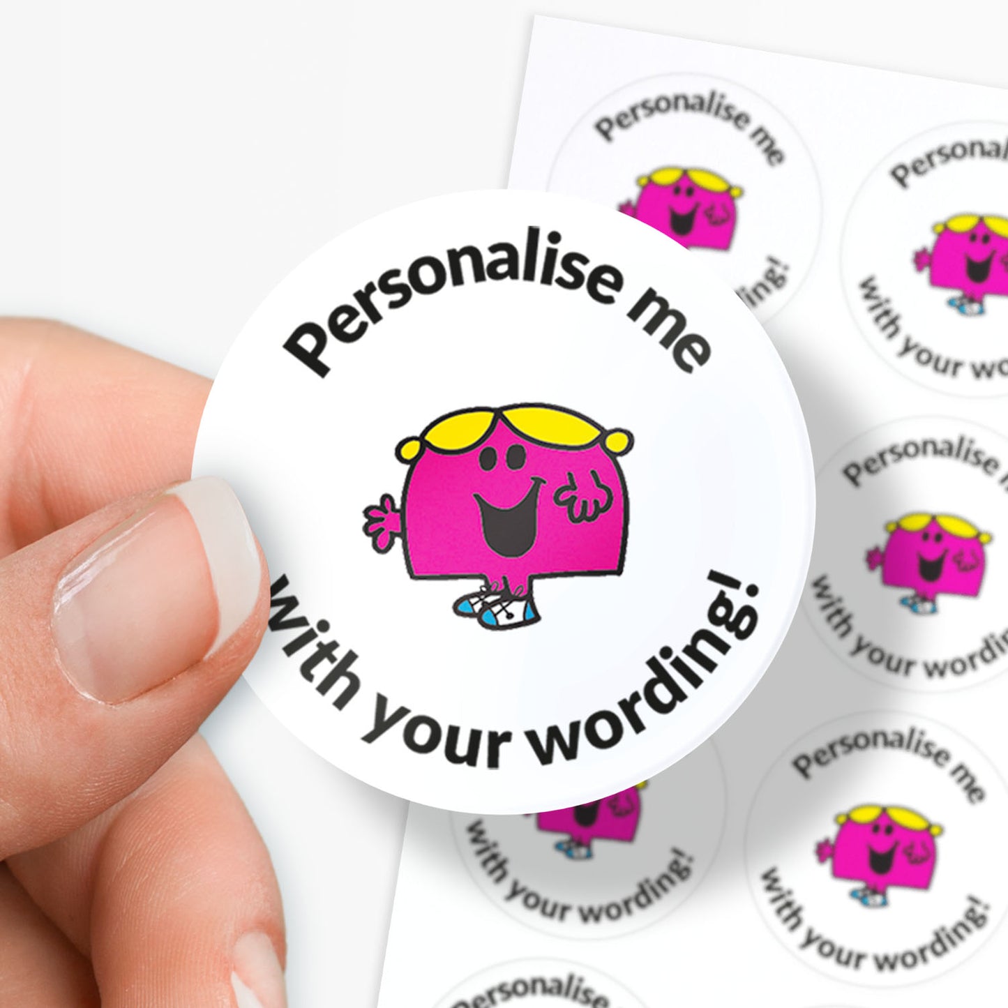 Circular sticker with a pink character and text 'Personalise me with your wording!' held by a hand.