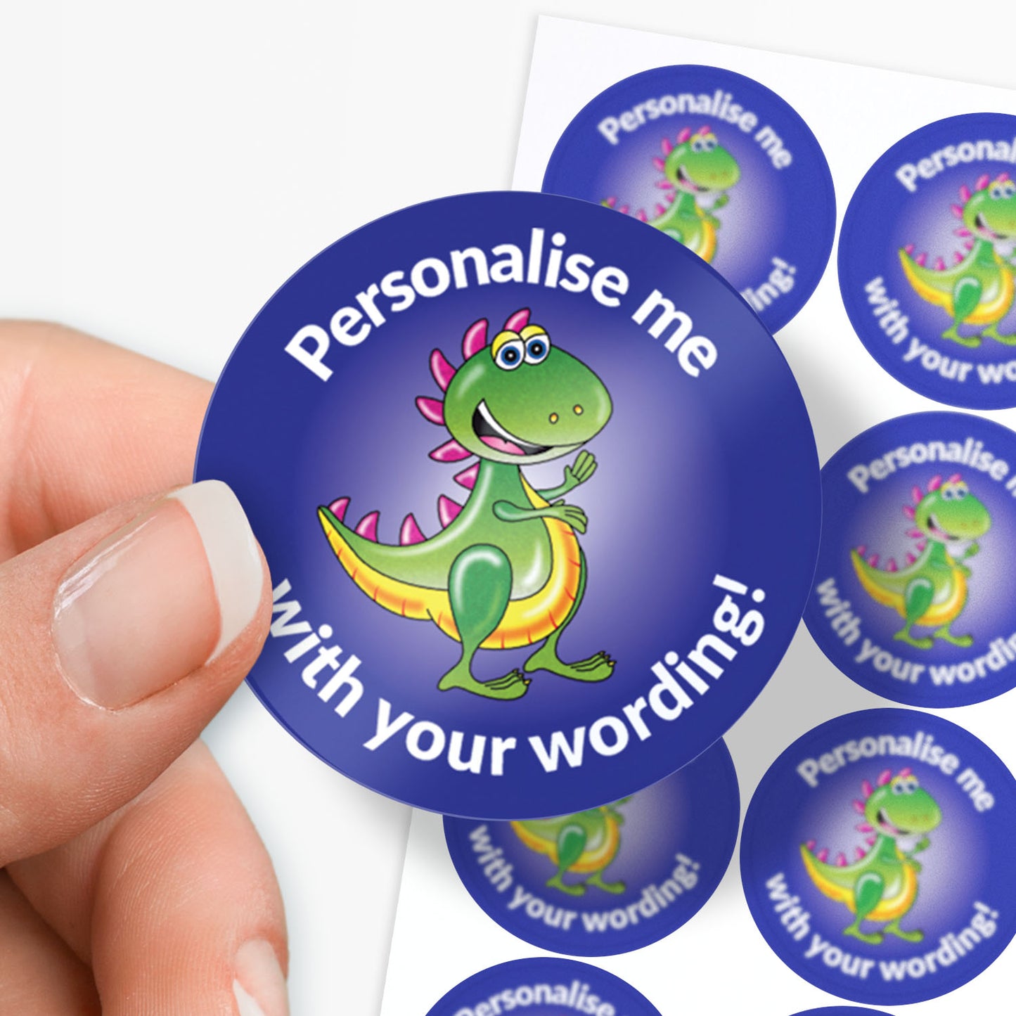 Sticker with a dinosaur design and text 'Personalise me with your wording!' held by a hand.