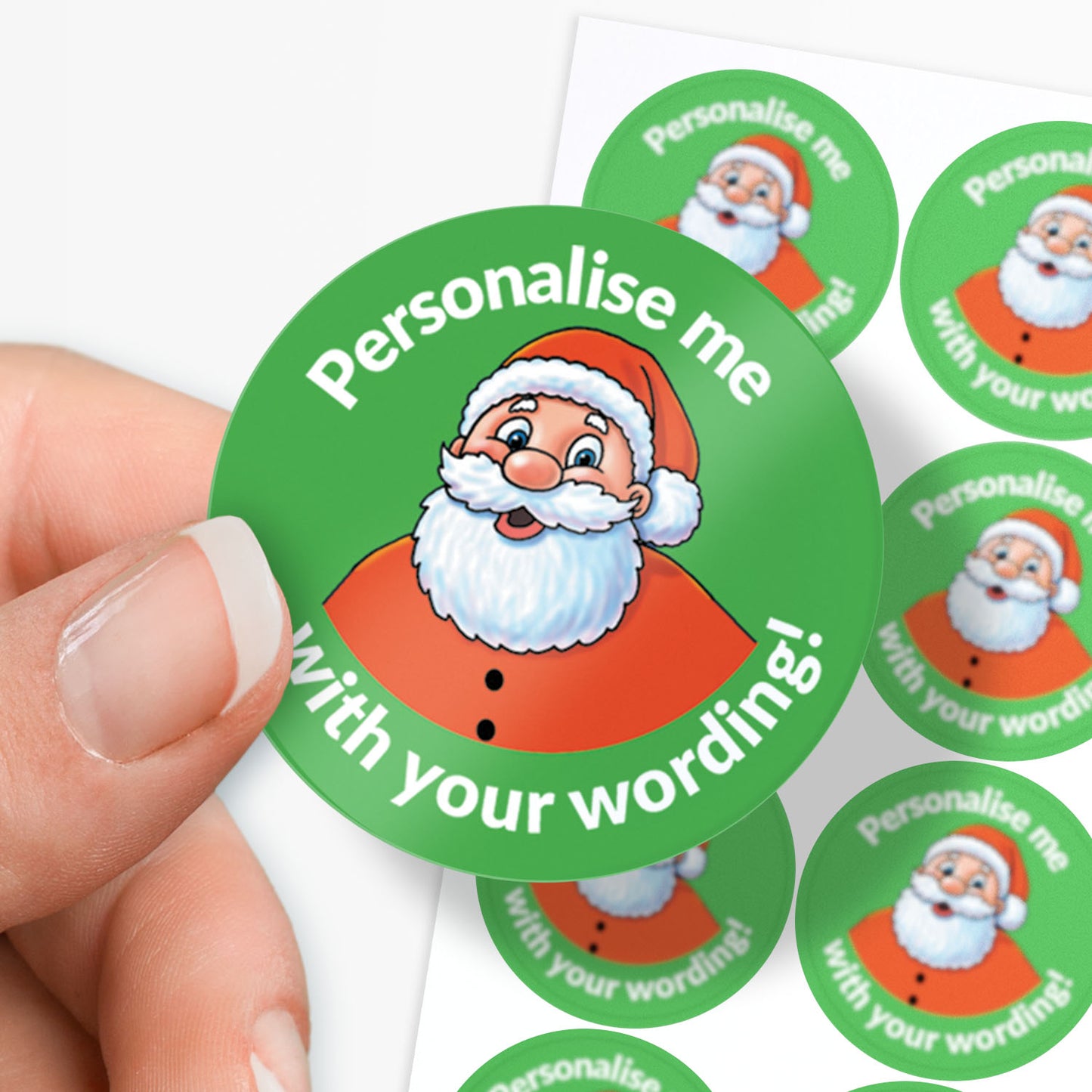 Circular sticker with Santa Claus design and text 'Personalise me with your wording!' held by a hand.