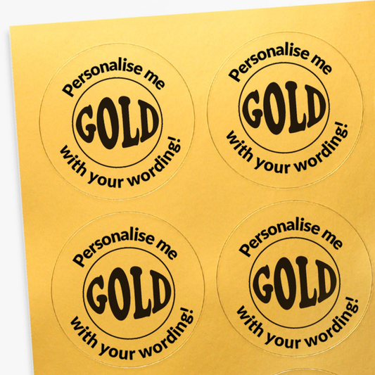 Four round gold stickers with black text on a yellow background