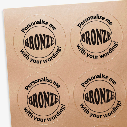 Four round stickers with bronze design and text on a bronze background