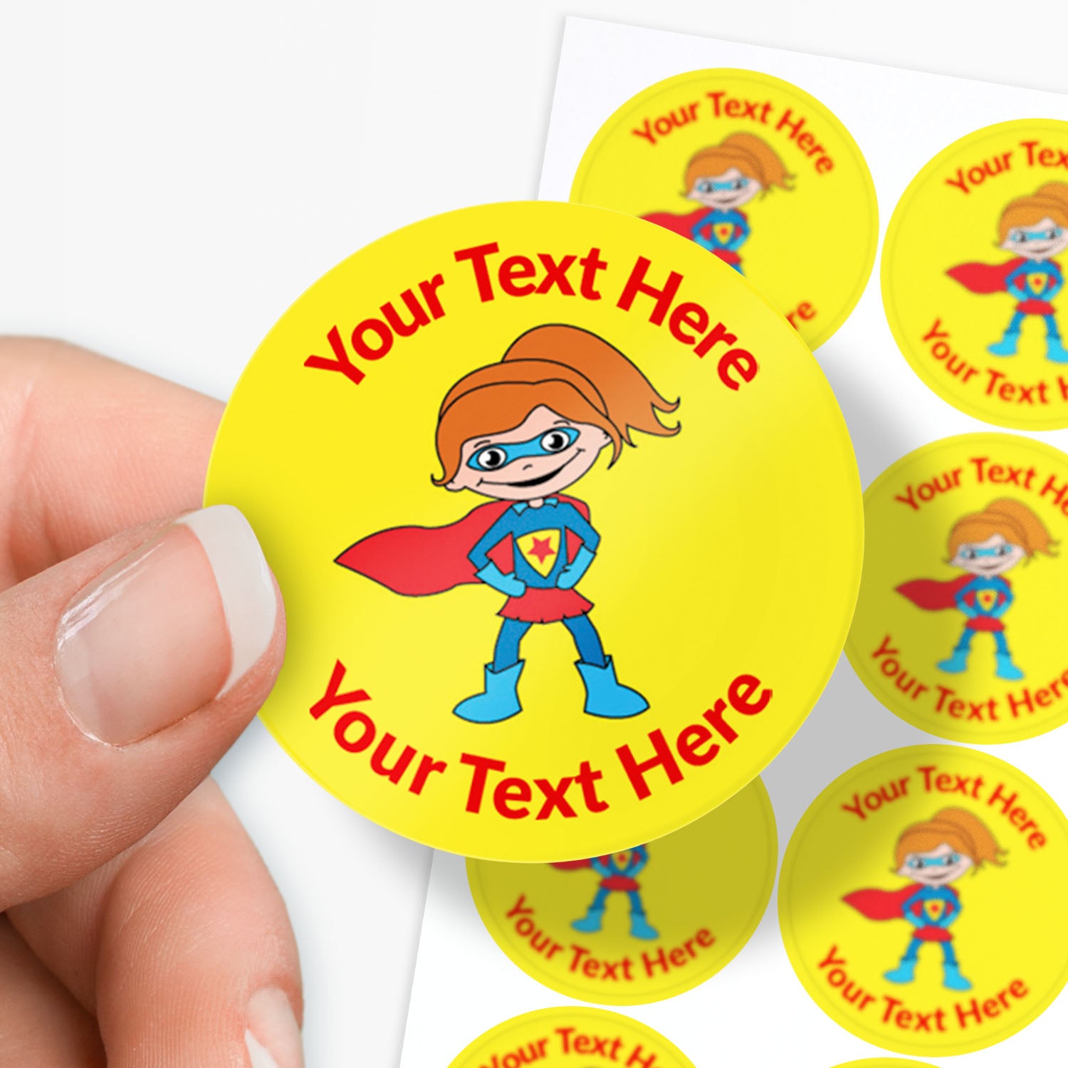Superhero-themed stickers with customizable text held by a hand