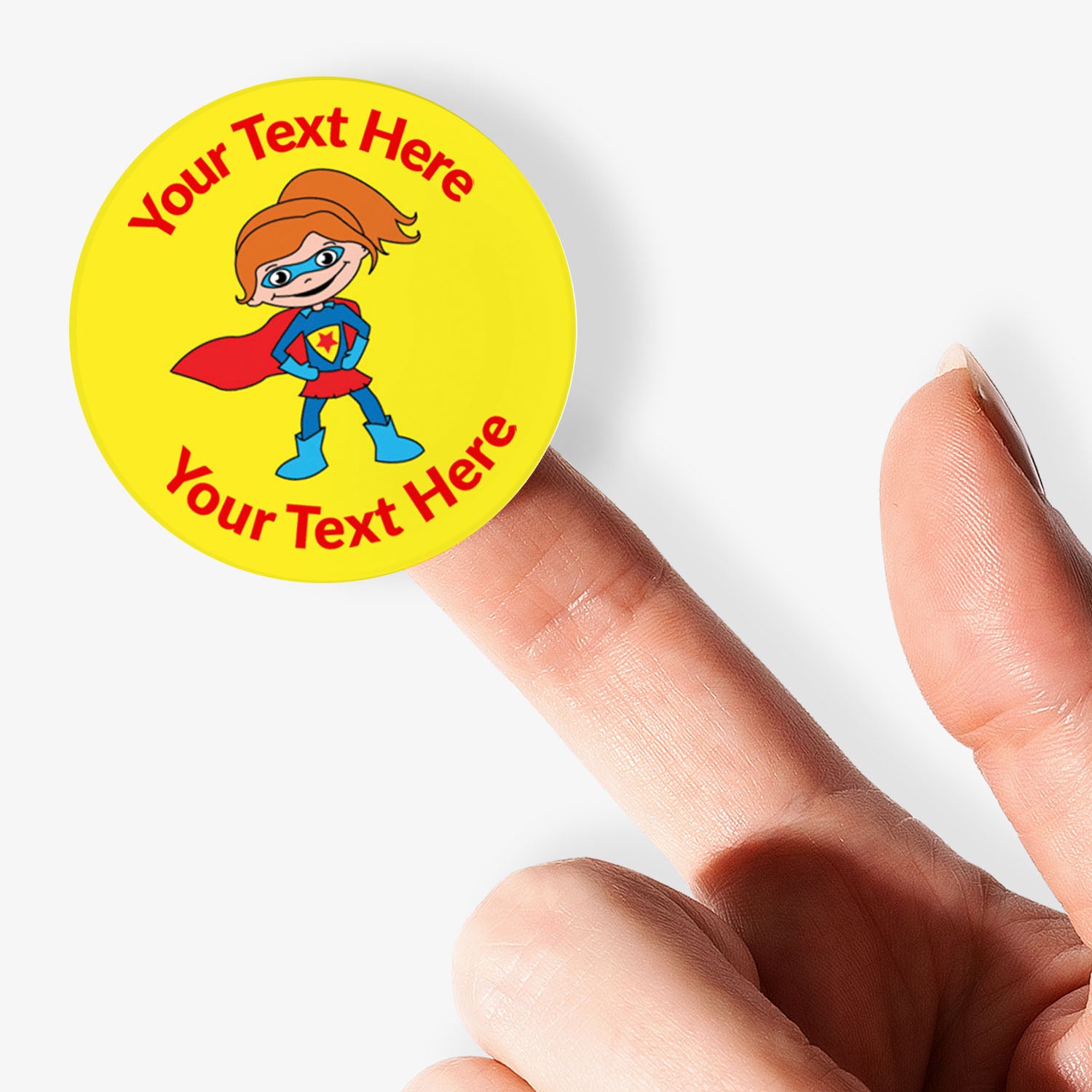 Superhero-themed sticker with customizable text held by a hand on a white background
