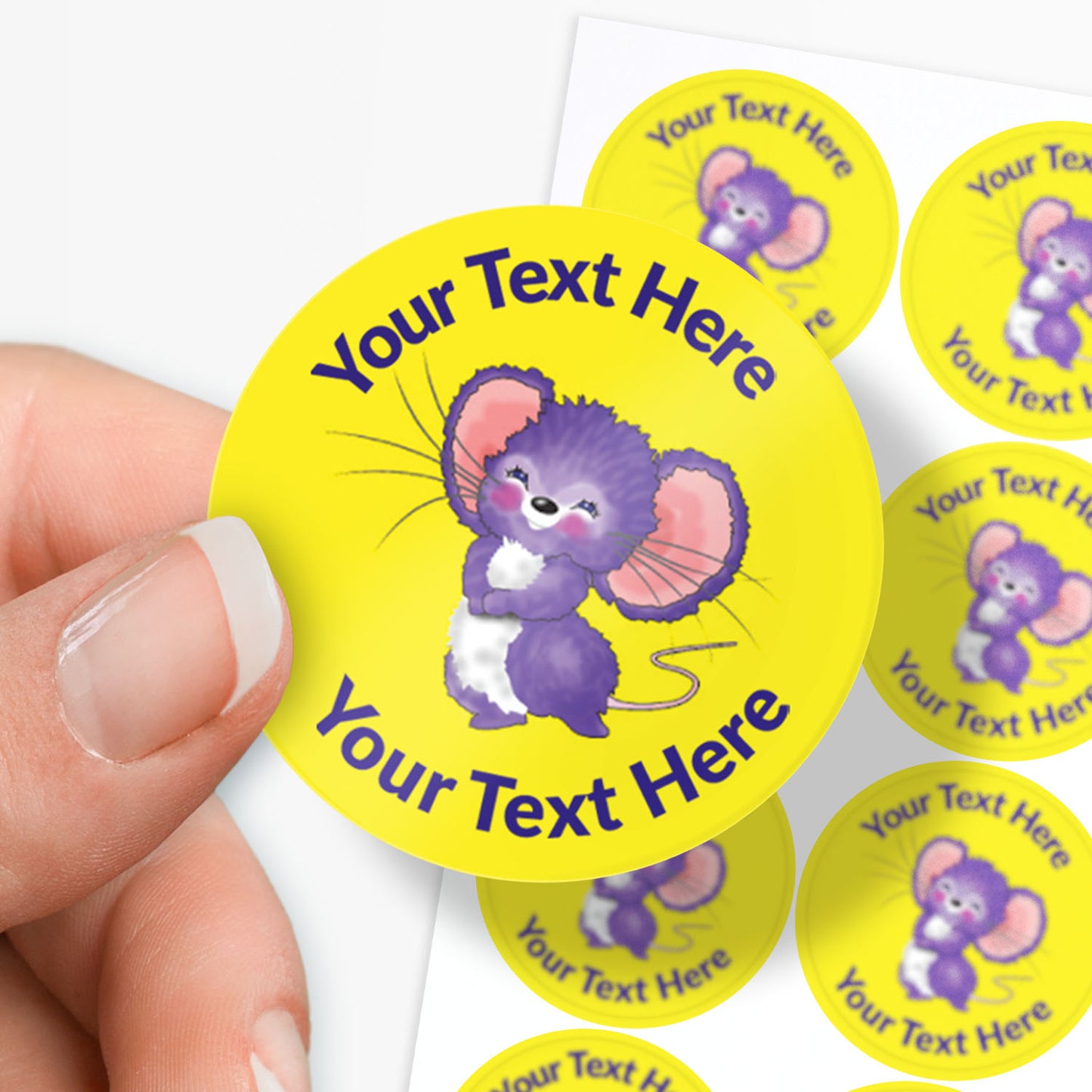Personalizable yellow stickers with a purple mouse design and text area, held by a hand.