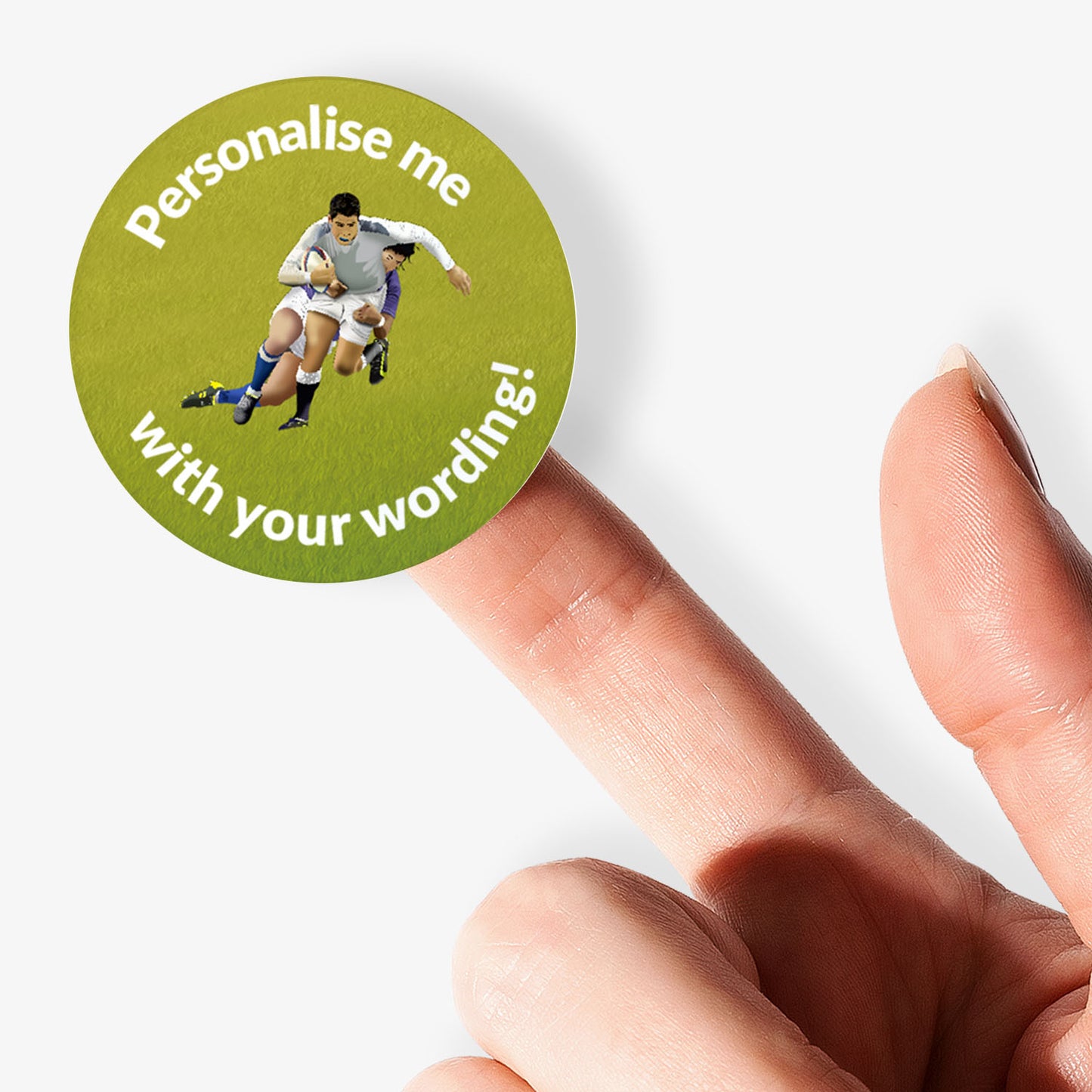 Round green sticker with rugby player graphic and text 'Personalise me with your wording!' held by a finger.