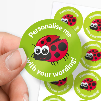 Circular stickers with a ladybug design and text 'Personalise me with your wording!' held by a hand.