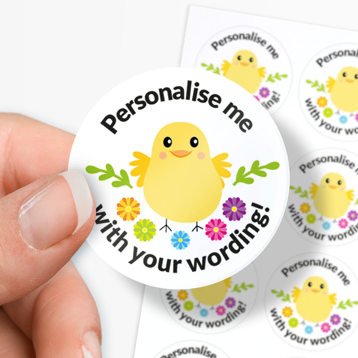 Round sticker with a chick design and text 'Personalise me with your wording!' held by a hand.