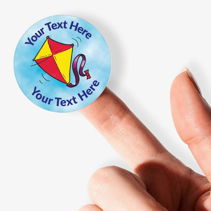Personalizable sticker with kite design held by a finger on a white background