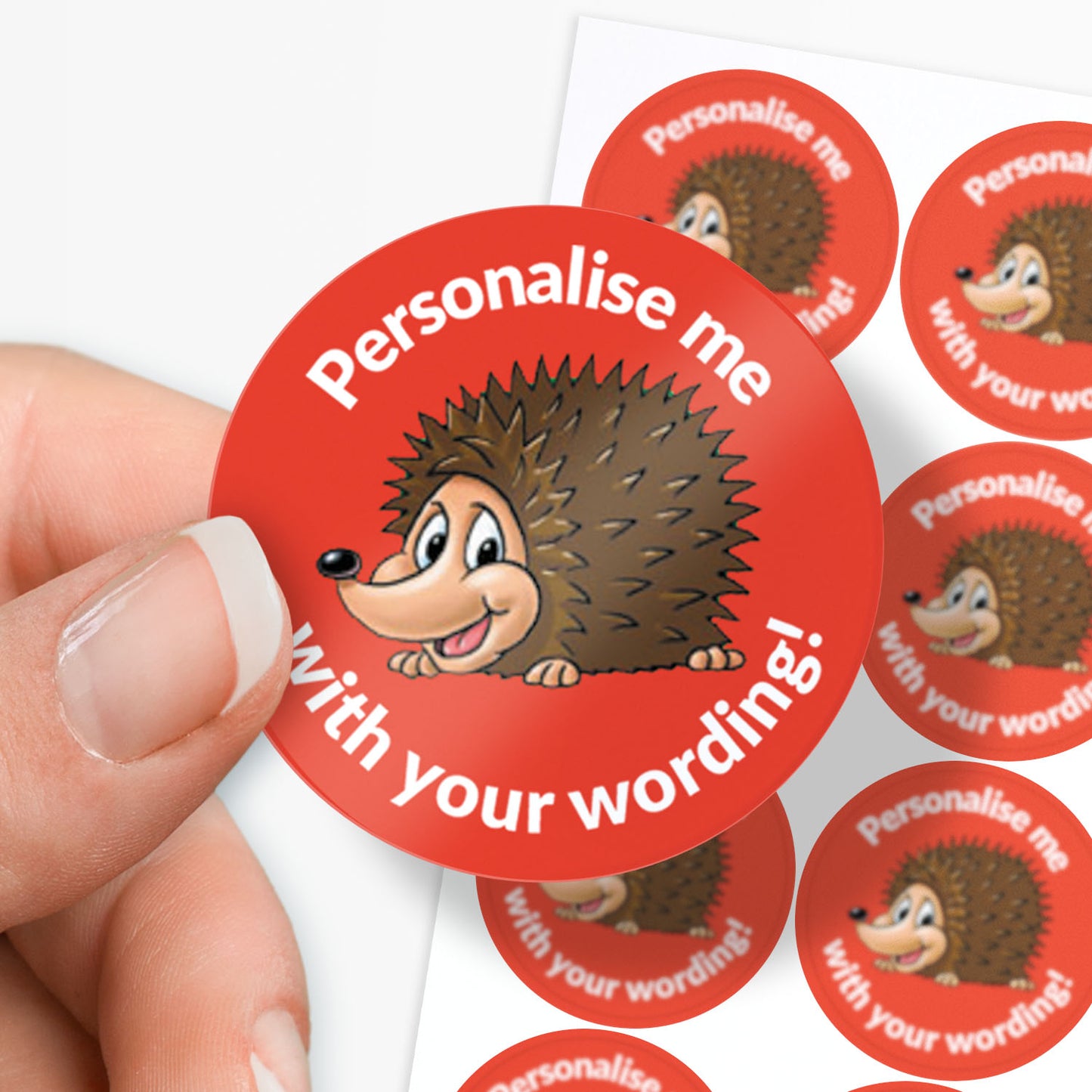 Red stickers with a smiling hedgehog as a central image.  Space for personalisation above and below the image.
