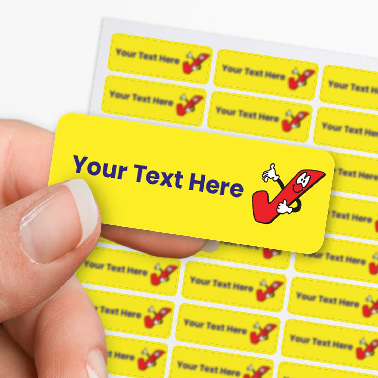 Yellow label with cartoon pencil character and customizable text area held by hand with sheet of sticker in the background.