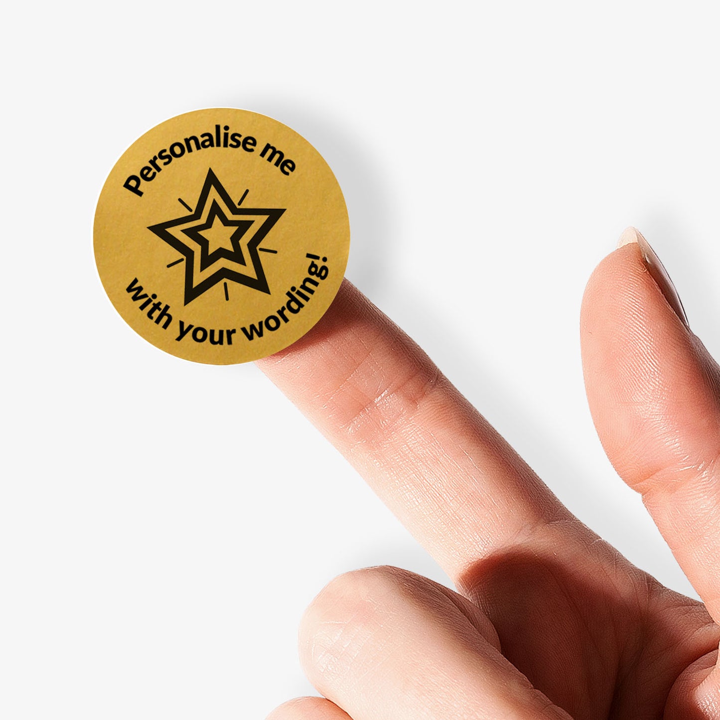 Gold stickers with a black star in the middle and text held by a finger