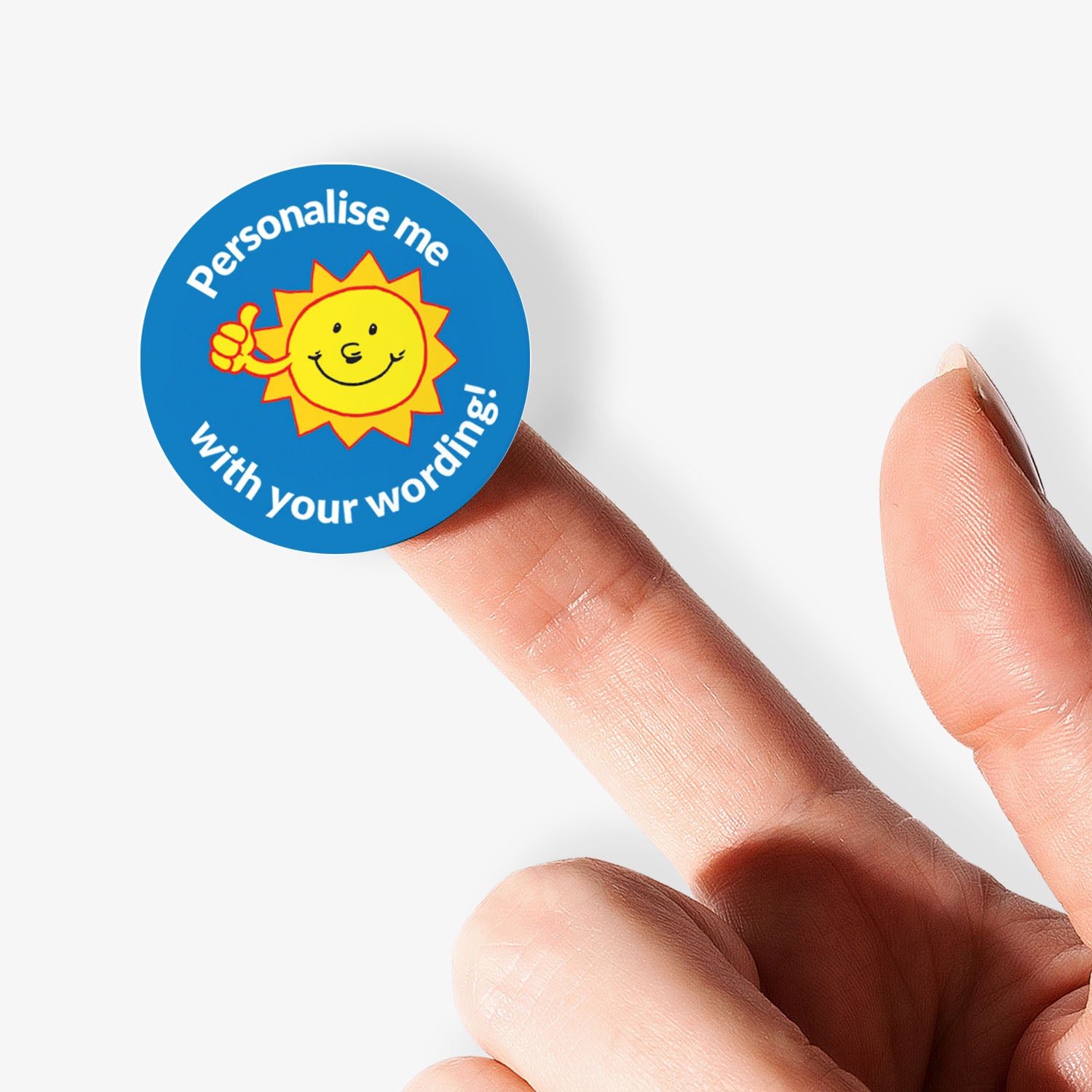 Round sticker with a sun design and text 'Personalise me with your wording!' held between fingers.