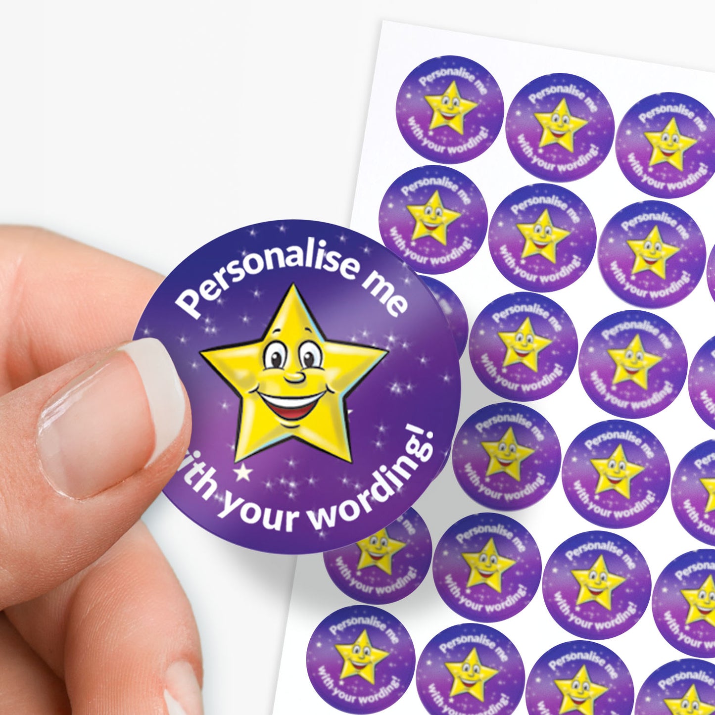 Sheet of circular purple stickers with a yellow cartoon star and text on a white background. Single sticker held between finger and thumb
